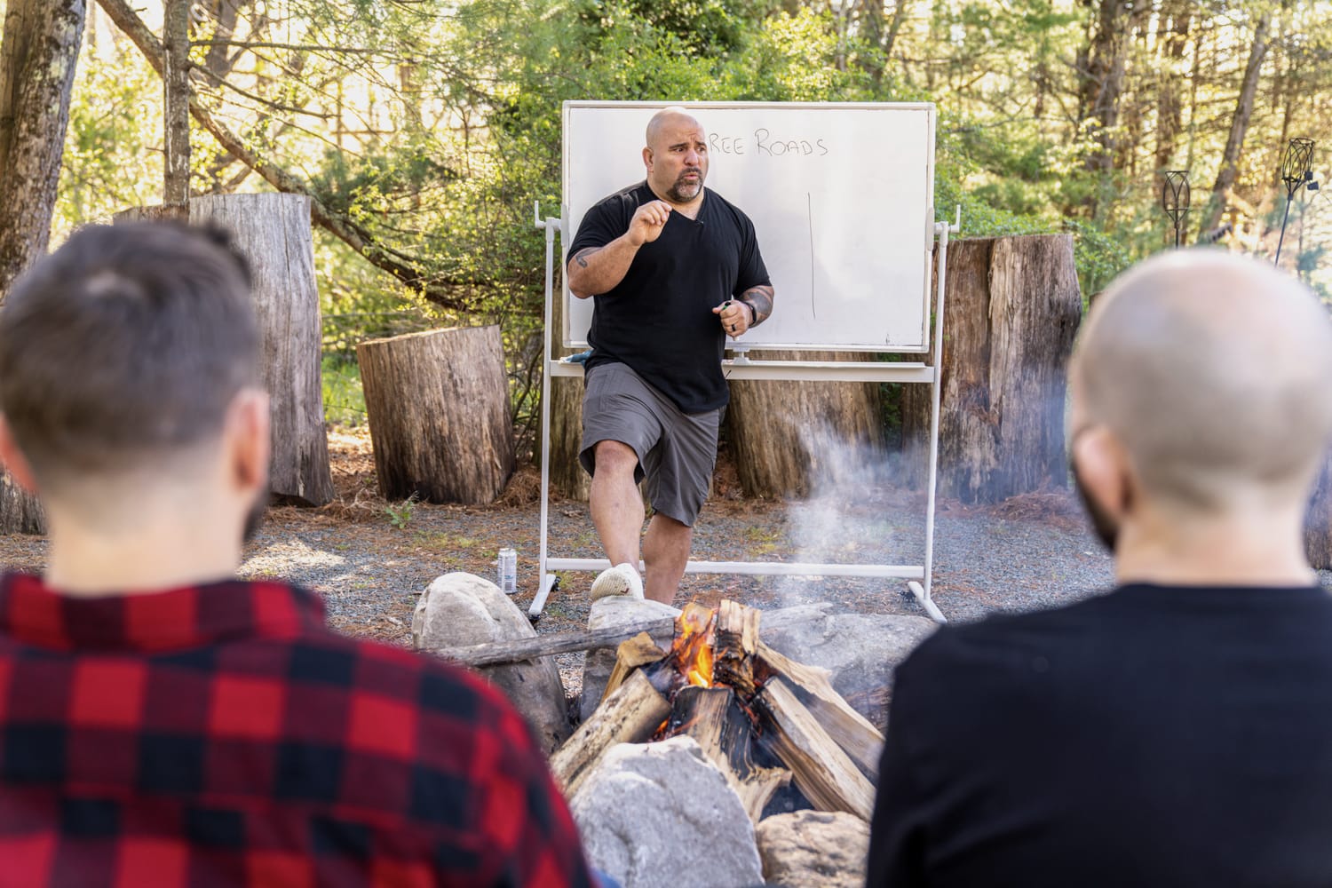 Master Chim teaching the series outdoors beside a fire at a prior PressureCon.