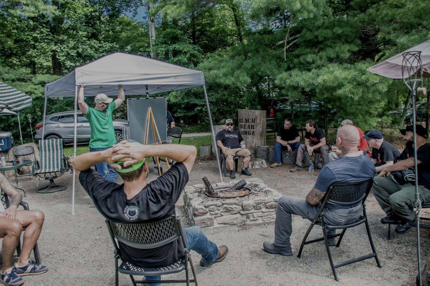 Attendees gathered around the fire pit under the tents during the Friday meet and greet at a prior PressureCon.