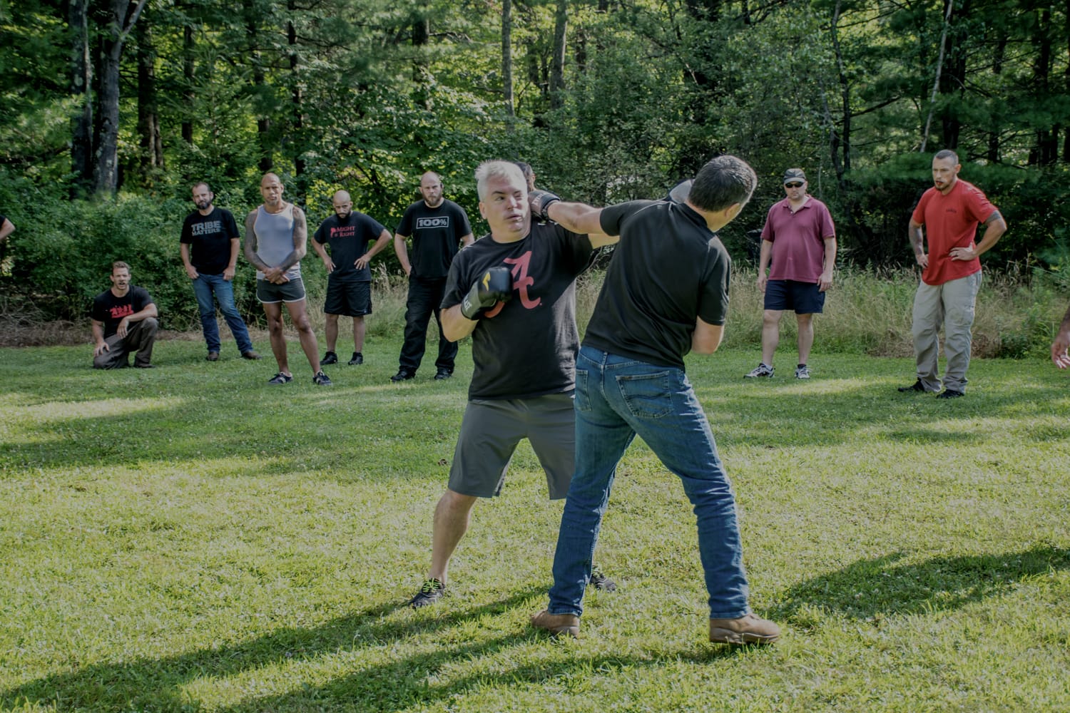 Attendees running a combatives drill in the field during a prior Pressure Sunday.